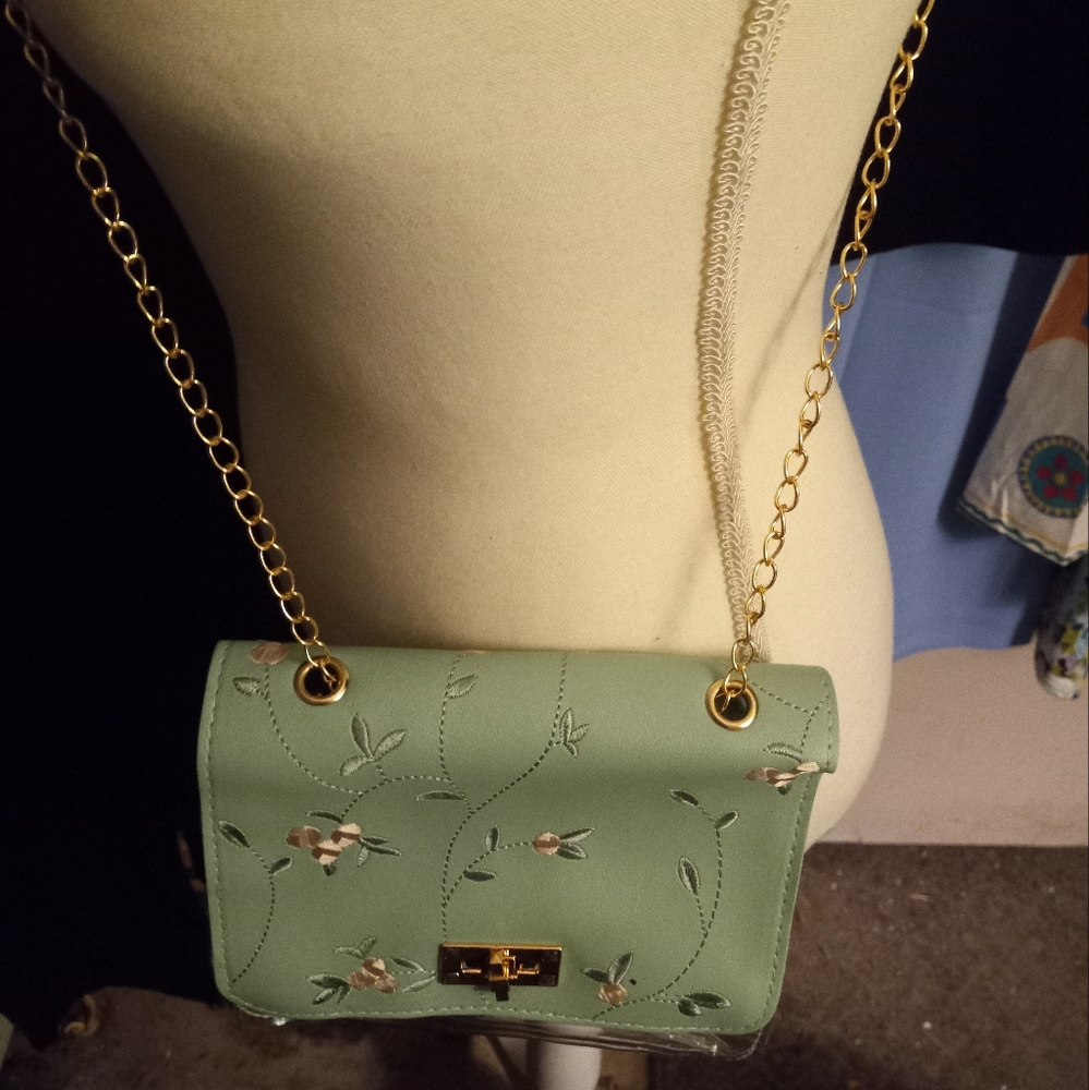 New,seaform green faux leather floral embroidered handbag with pu vinyl back.